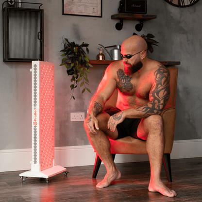 Man sat using half body red light therapy panel