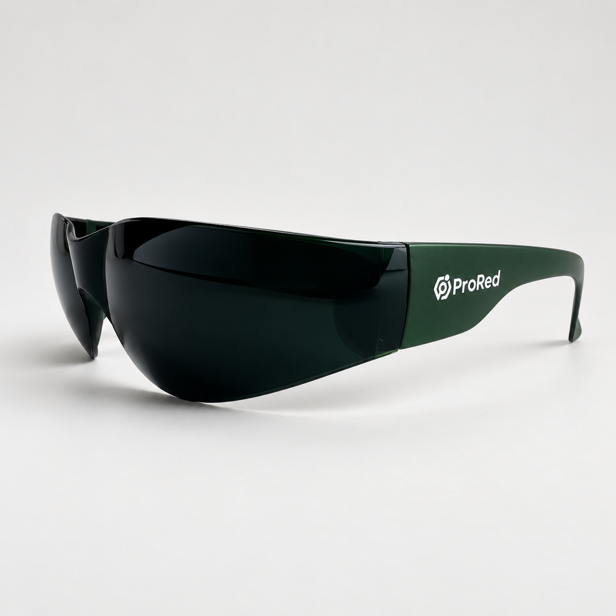 Shield-style sunglasses with dark tinted lenses and a green temple arm featuring the white ProRed logo, shown on a clean light gray studio background.