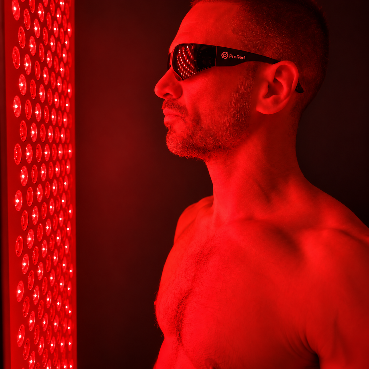 Man wearing prored glasses infront of panel