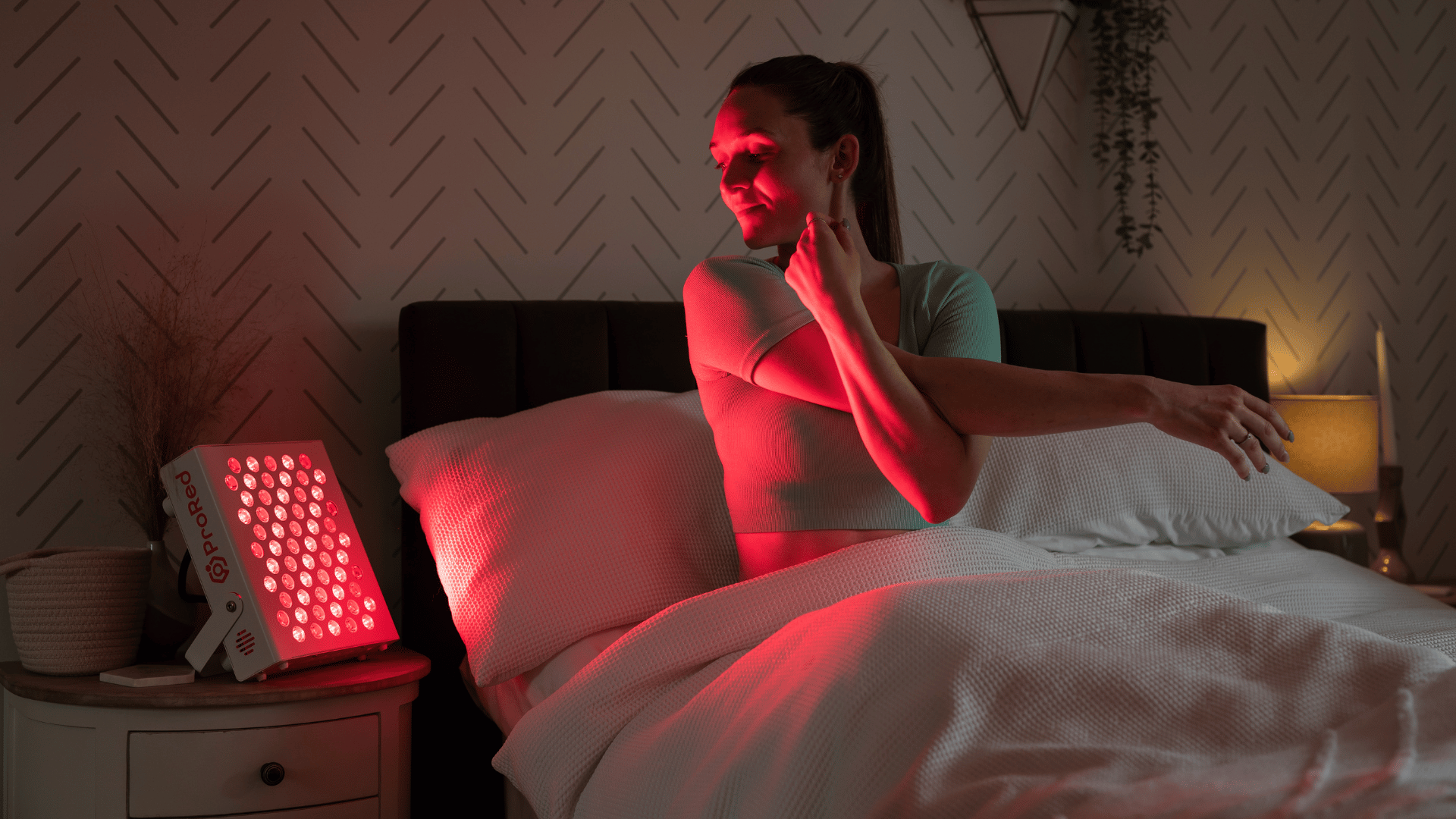 Girl stretching while doing red light therapy