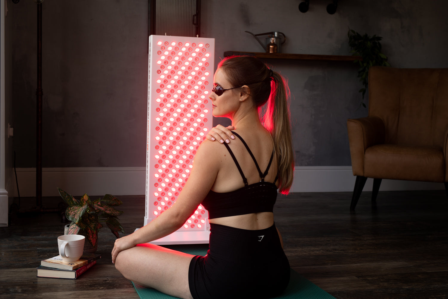 yoga girl sat doing red light therapy